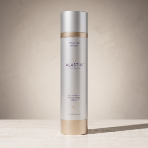 ALASTIN A-LUMINATE Brightening Serum, 1.7 fl oz, on a neutral stone surface