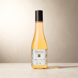 Eminence Apricot Body Oil, 240 ml, on a neutral stone surface