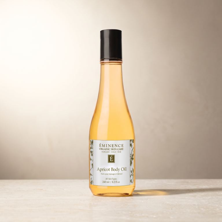 Eminence Apricot Body Oil, 240 ml, on a neutral stone surface