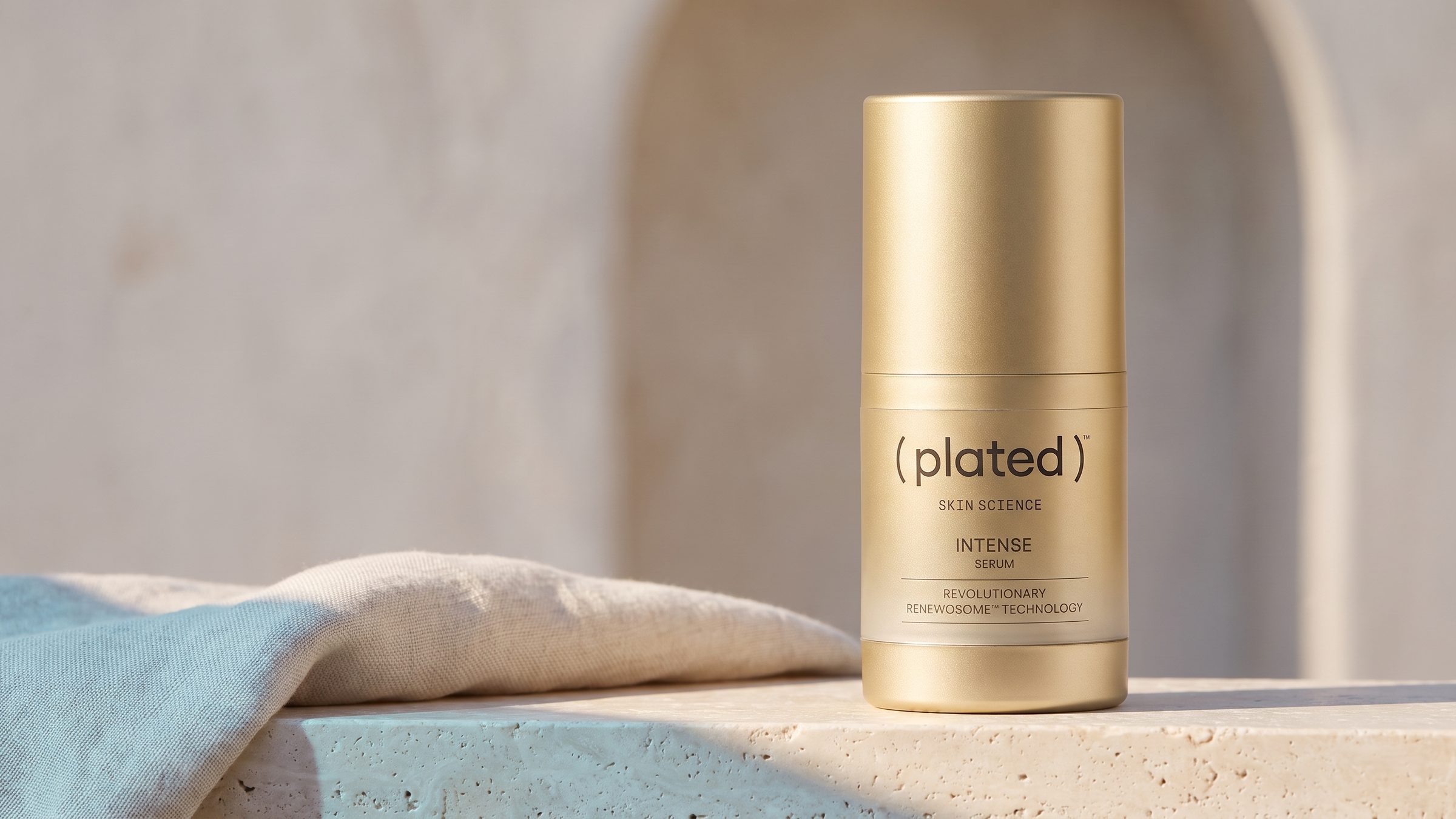 Plated INTENSE Serum on a travertine ledge in morning light